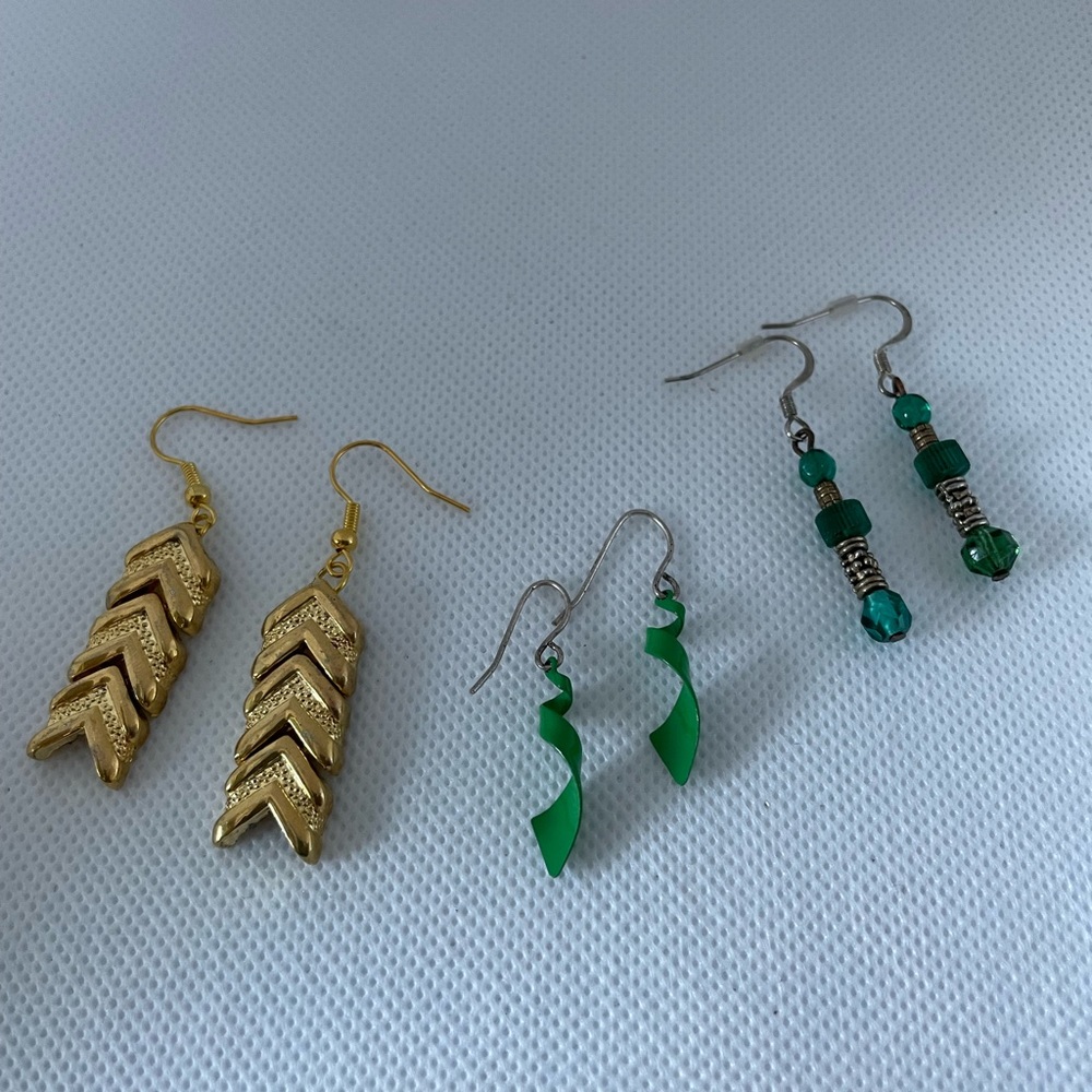 3 pairs- 1 gold tone V-shape, 2- Green dangling earrings